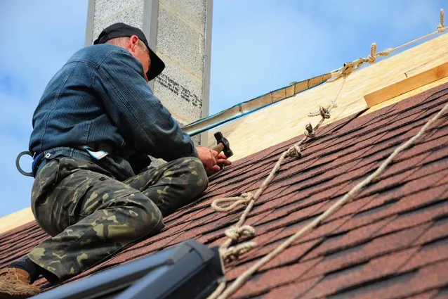 Roofer Hard at Work | Red River Roofing, Siding and Windows